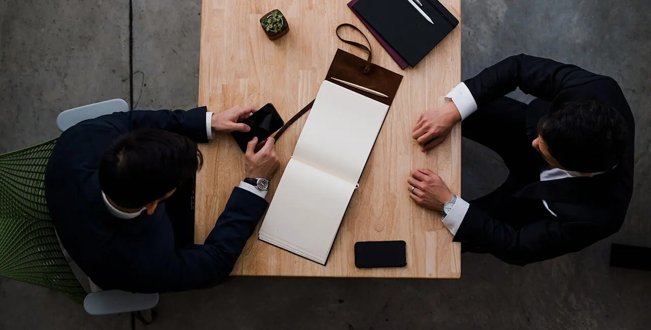 Two business advisers meeting at a desk